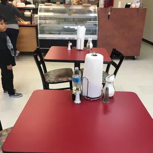 a red table and chairs in a restaurant