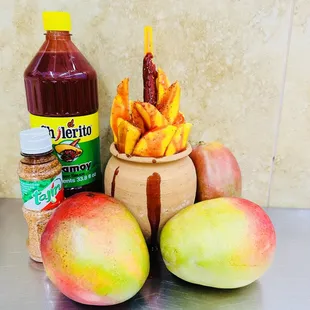 a bowl of fruit and a bottle of juice