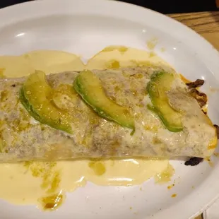 Burrito California 10¨flour tortilla stuffed with bellpeppers, tomatoes, onion, rice and beans with grilled chicken, steak, and shrimp.