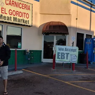 a man walking in front of a store