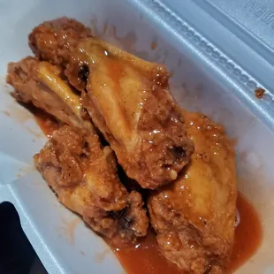 a chicken dish in a styrofoam container