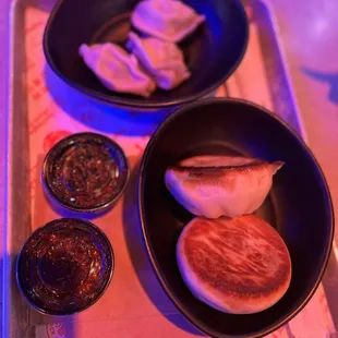 two bowls of food on a tray