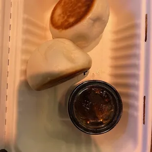 two buns in a styrofoam container