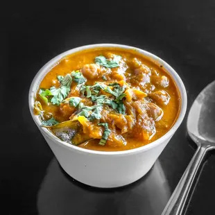 a bowl of soup with a spoon
