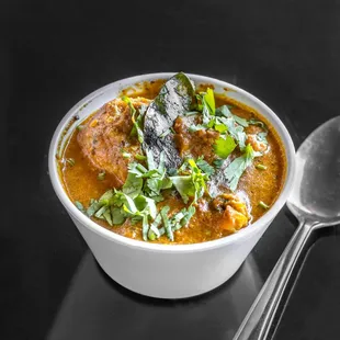 a bowl of soup and a spoon