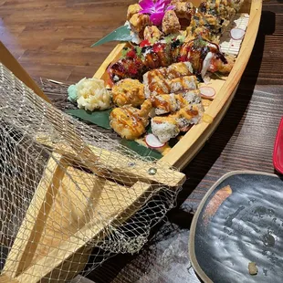 Sunset role on the "fan tail", rainbow dragon roll in the middle and I forgot what my friend ordered.