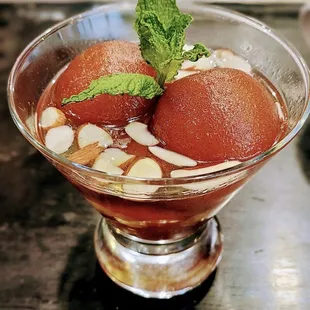 Gulab Jamun - Milk Dumplings in a warm sweet syrup. Almost like a syrup-soaked mini pancake!