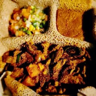 Lamb tibs with tomato salad and lentils. Take out