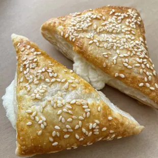 two pastries with sesame seeds on top