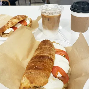 a croissant sandwich and a cup of coffee