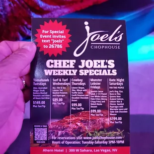 a hand holding a menu for joe's chophouse