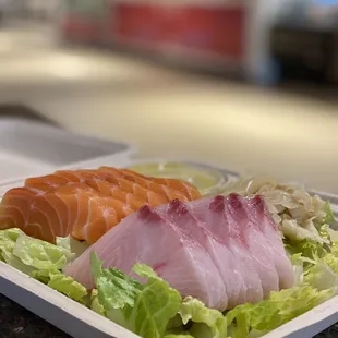 a sushi dish in a styrofoam container