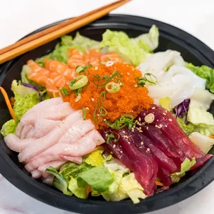 a bowl of food with chopsticks