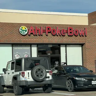 a pickup truck parked in front of a store