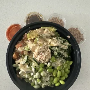 Regular Poke Bowl:  white rice, salmon, crab meat, seaweed salad, cucumber, avocado, sesame seeds.