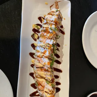 a plate of sushi with sauce