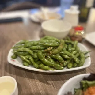 a plate of green beans and a salad