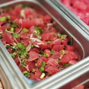 a close up of a salad in a metal container