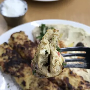 a fork holding a piece of food