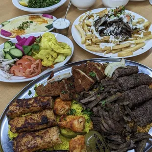 Combo platter for two, Jido&apos;s shawarma (Gus) fries, curry potato stew &amp; white bean stew, tabbouli, turshee (pickles), hummus, pita bread