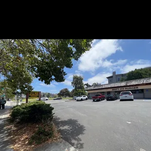 Parking lot and open green space across the street.