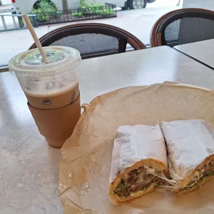 Iced latte and steak and cheese sandwich