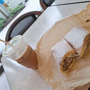 Iced latte and steak and cheese sandwich