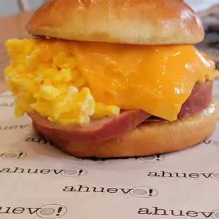 Ahuevo
 cage-free soft scrambled eggs &amp; chopped chives, cheddar cheese, caramelized onions &amp; sriracha mayo, brioche bun/Added Canadian Bacon