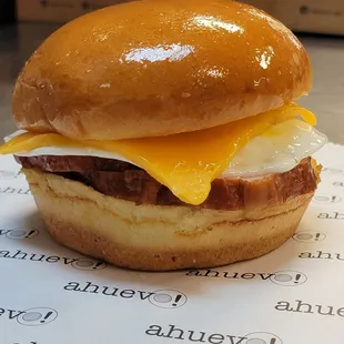 Canadian bacon, over-easy egg, cheddar chesse with mayo sriracha on a warm brioche bun