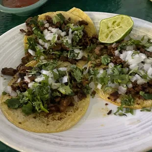 Carne Asada tacos w white onion, cilantro, lime on in house made corn tortilla