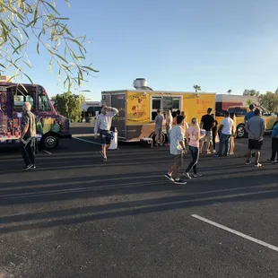 a group of people standing in a parking lot