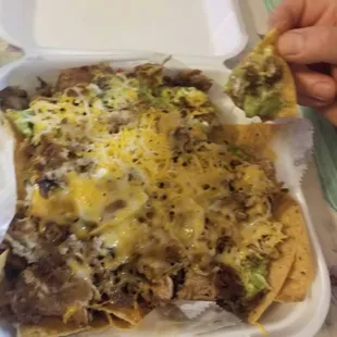 Super Nachos, choice of meat (Asada, pollo, carnitas, or pastor) cheese, guacamole, sour cream pico de gallo, and beans.