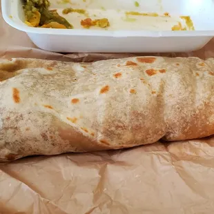 Chilie Bandido Burrito next to empty taquito container for size.