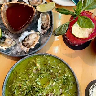 a plate of oysters and a bowl of salsa