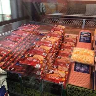 a display case of cheese and sausages