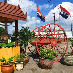 a wagon wheel and potted plants