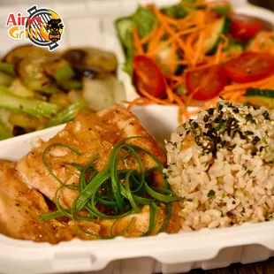 chicken, rice and vegetables in a styrofoam container