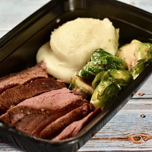 Smoked Sirloin w/ homemade mashed potatoes and roasted Brussels sprouts, available through our meal prep services