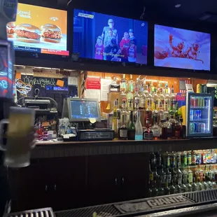 a bar with several televisions