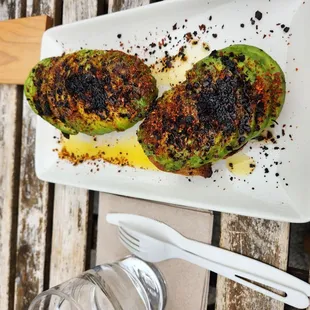 Avocado toast - $12 Two chunky slices of toast with about a whole avocado on top + chili crisp oil.