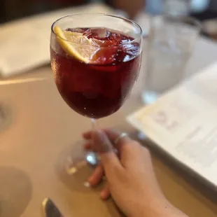 a person holding a glass of wine