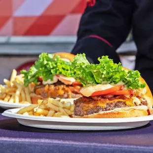 a person holding a plate of fries