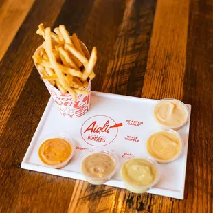 a tray of fries and dipping sauces