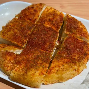 Grilled flatbread with spicy sauce