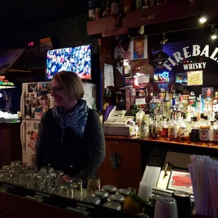 a woman behind the bar