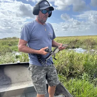 Captain Jeremy holding two gator pistols.