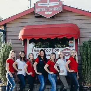 a group of women standing in front of a restaurant