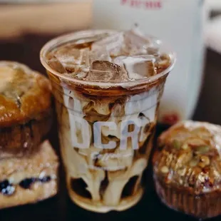 a cup of iced coffee and muffins