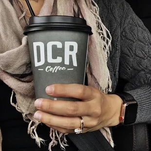 a woman holding a coffee cup