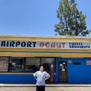 a man standing in front of a deli